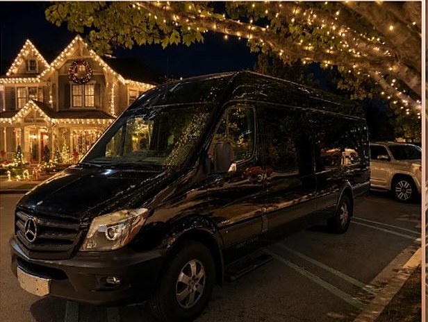 Social Luxury Sprinter parked in front of a Tulsa home lit up for Christmas
